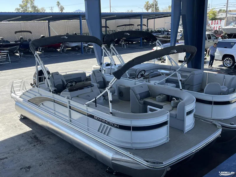 Slide: The Image of 2023 Bennington 23LSB pontoon boat displayed in a showroom. - 5