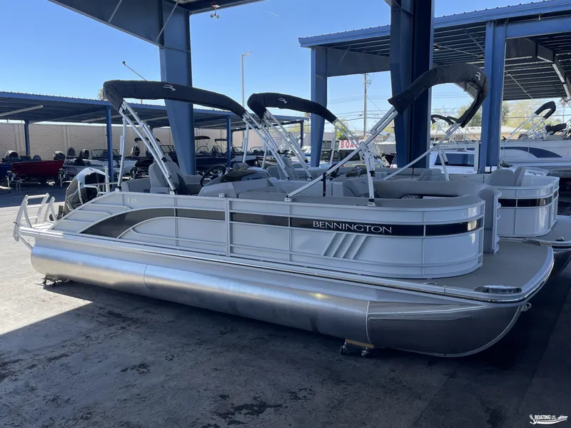 Slide: The Image of 2023 Bennington 23LSB pontoon boat in a covered marina. - 6
