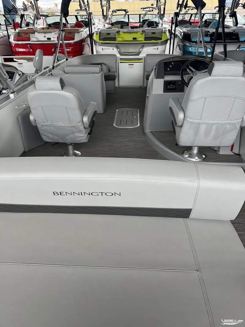 Slide: The Image of 2023 Bennington 23LSB pontoon boat interior with gray seating and steering console. - 9