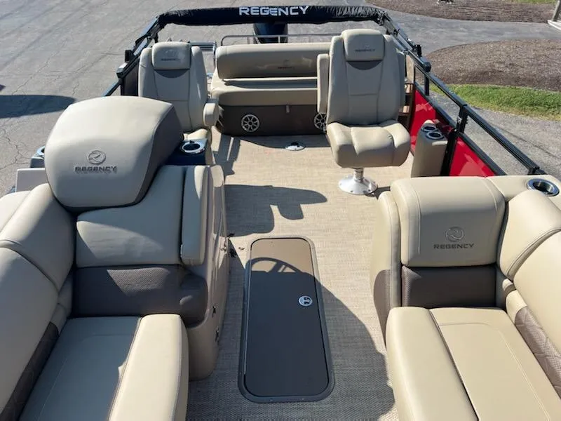 Slide: The Image of 2023 Regency 230 LE3 Sport pontoon boat with beige seating and spacious deck. - 4