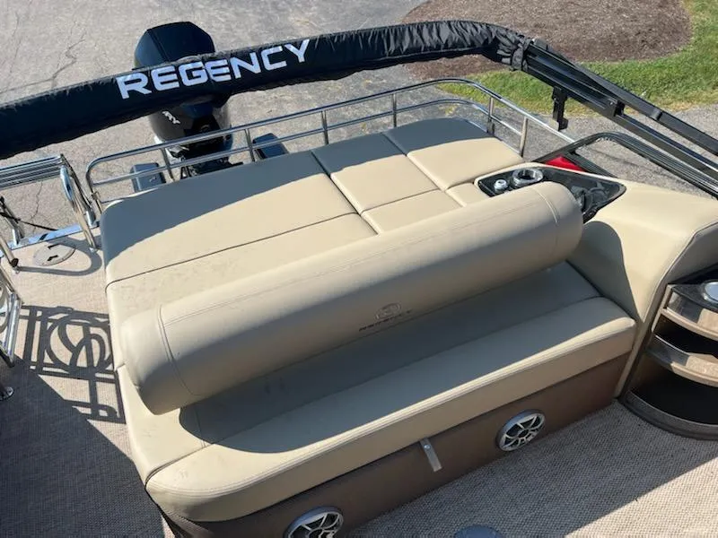 Slide: The Image of 2023 Regency 230 LE3 Sport boat with beige seating and black accents. - 5