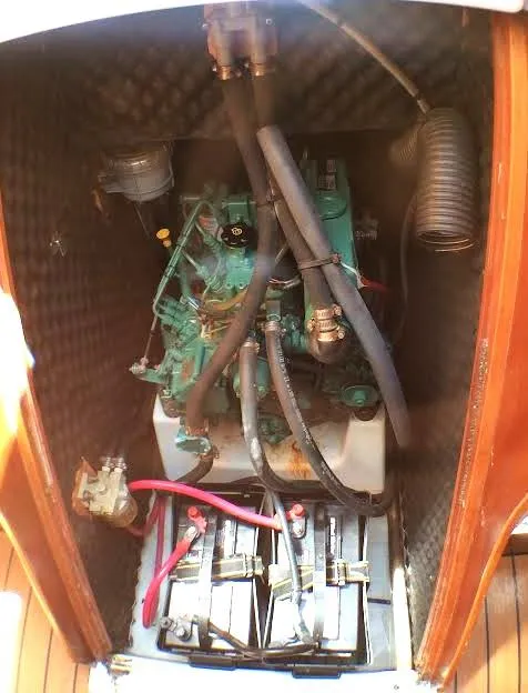 Slide: The Image of Engine compartment of a 2003 Beneteau First sailboat, featuring visible wiring and components. - 17