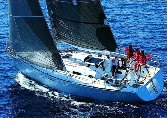 Slide: The Image of 2003 Beneteau First sailboat navigating blue ocean waters with crew on deck. - 4