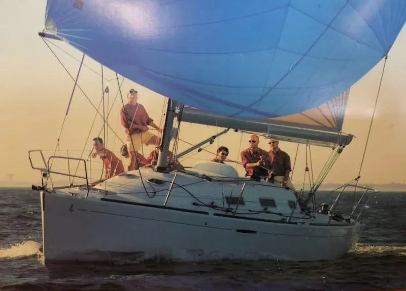 Slide: The Image of Sailing on a 2003 Beneteau First yacht with a blue spinnaker in open waters. - 5