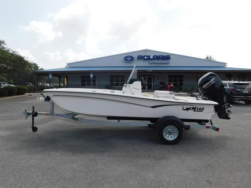 Slide: The Image of 2023 Mako Pro Skiff 15 CC boat on trailer outside Polaris dealership. - 0