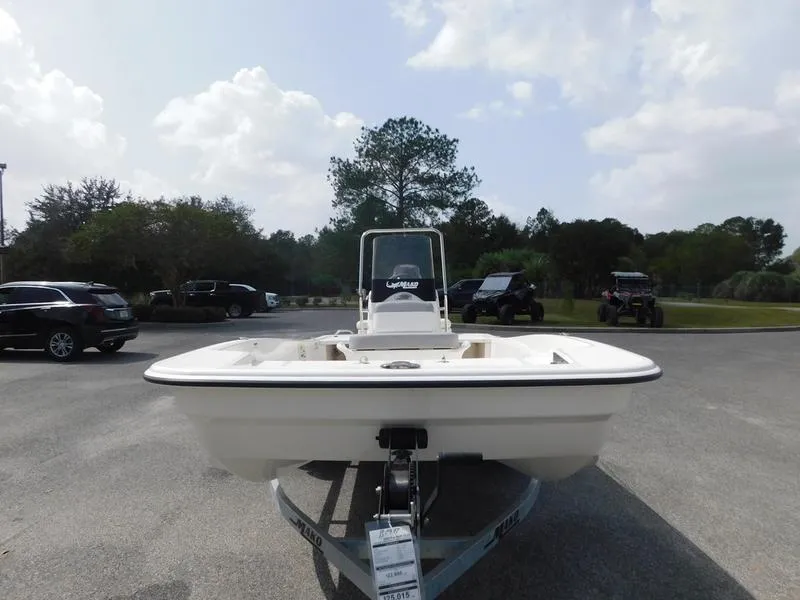 Slide: The Image of 2023 Mako Pro Skiff 15 CC boat on trailer in outdoor parking lot. - 2