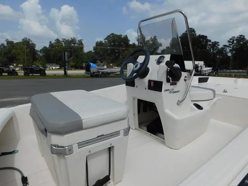 Slide: The Image of 2023 Mako Pro Skiff 15 CC boat interior with console and seating. - 5