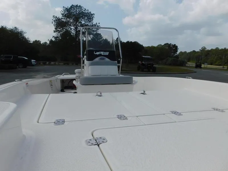 Slide: The Image of 2023 Mako Pro Skiff 15 CC boat with center console in a parking lot. - 7