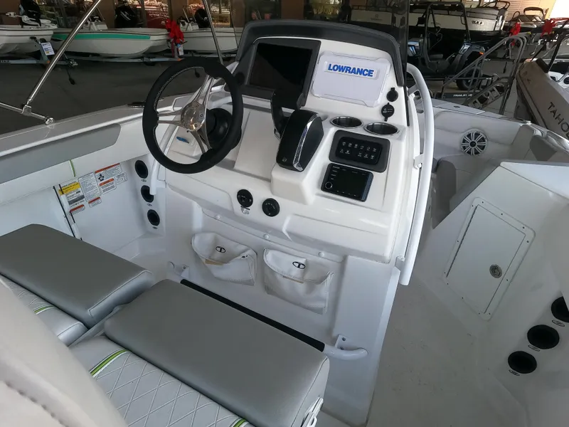 The Image of 2023 Tahoe 2150 CC boat interior with steering wheel and control panel. - 0