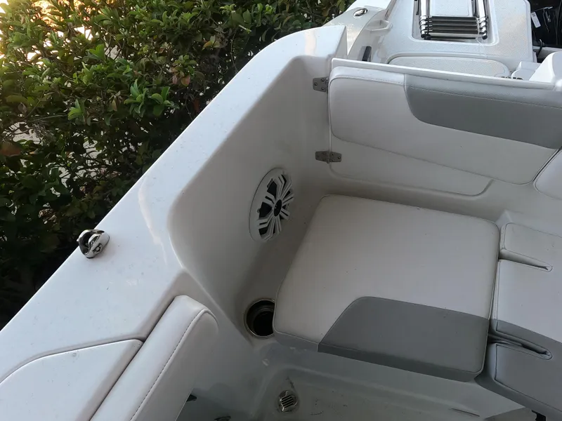 Slide: The Image of 2023 Tahoe 2150 CC boat interior with white seating and speaker. - 7