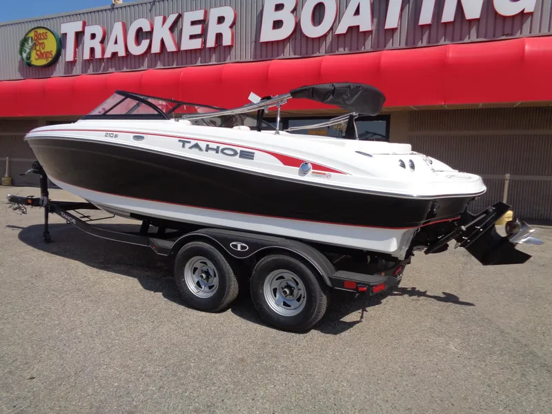 Slide: The Image of 2023 Tahoe 210 Si boat on trailer outside Tracker Boating store. - 2