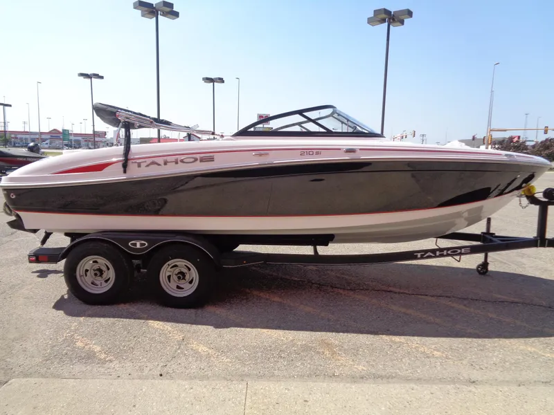Slide: The Image of 2023 Tahoe 210 Si boat on a trailer in a parking lot. - 3