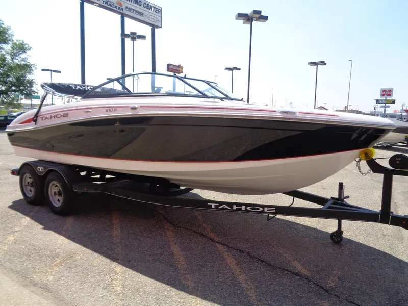 Slide: The Image of 2023 Tahoe 210 Si boat on trailer in parking lot. - 4