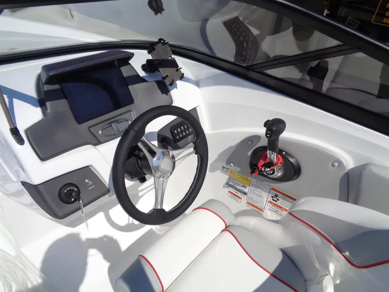 Slide: The Image of 2023 Tahoe 210 Si boat dashboard with steering wheel and control panel. - 8