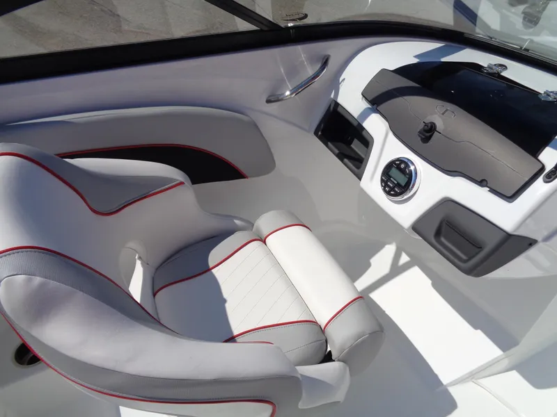 Slide: The Image of 2023 Tahoe 210 Si boat interior with white and red captain's chair and dashboard. - 9