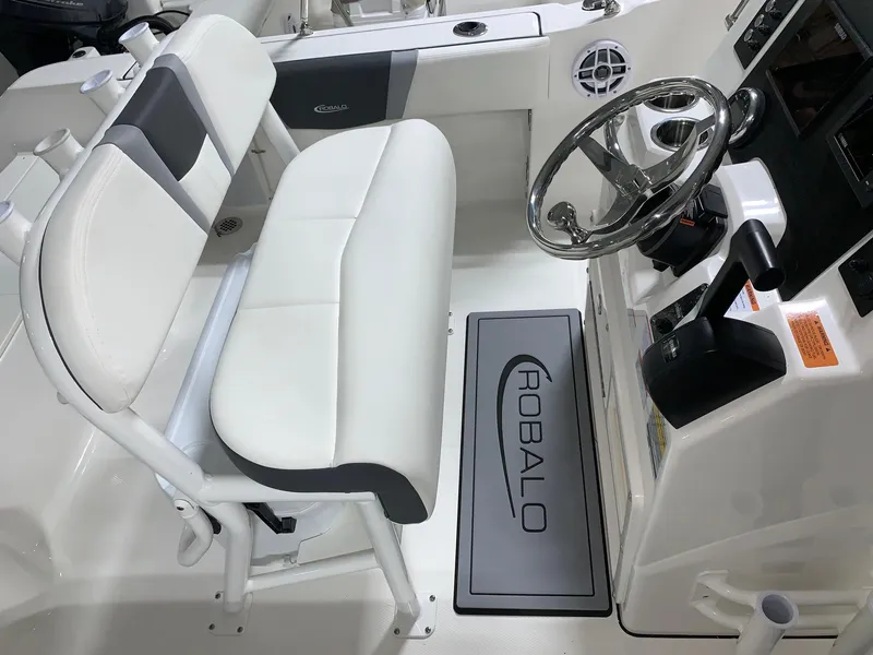 Slide: The Image of 2024 Robalo R180 Center Console boat interior with steering wheel and seating. - 10