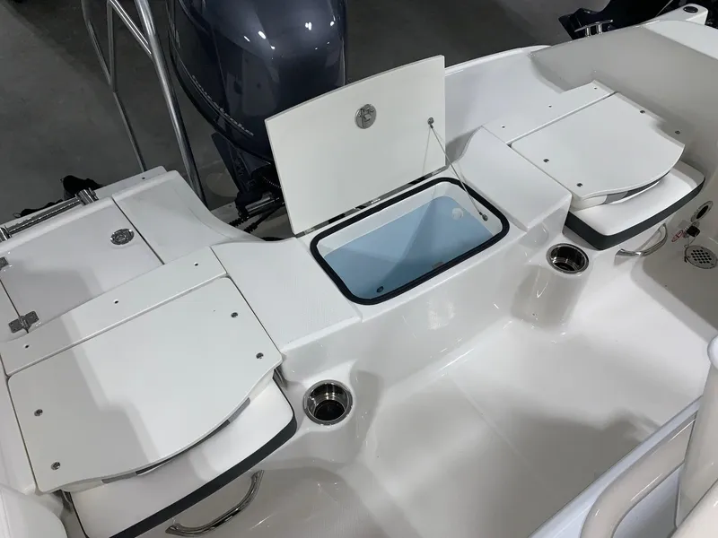 Slide: The Image of 2024 Robalo R180 Center Console boat with open storage compartments. - 12