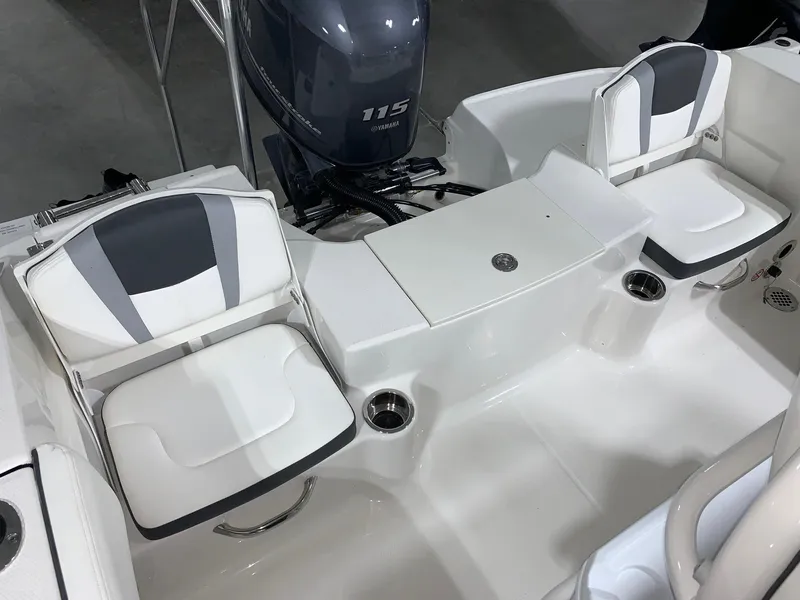 Slide: The Image of 2024 Robalo R180 Center Console boat interior with seating and 115 HP engine. - 13
