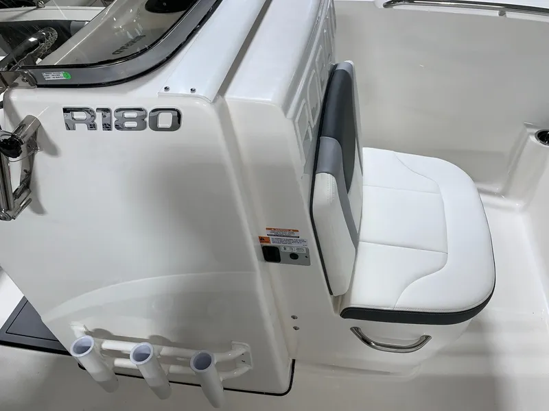 Slide: The Image of 2024 Robalo R180 Center Console boat interior with seating and rod holders. - 5