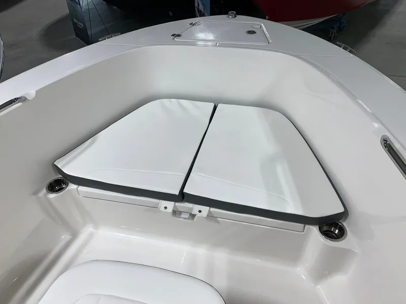 Slide: The Image of 2024 Robalo R180 Center Console boat bow seating area with white cushions. - 6