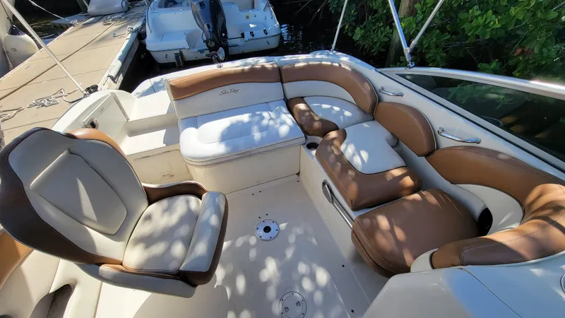 Slide: The Image of 2007 Sea Ray SunDeck 200 boat interior with tan and white seating. - 13