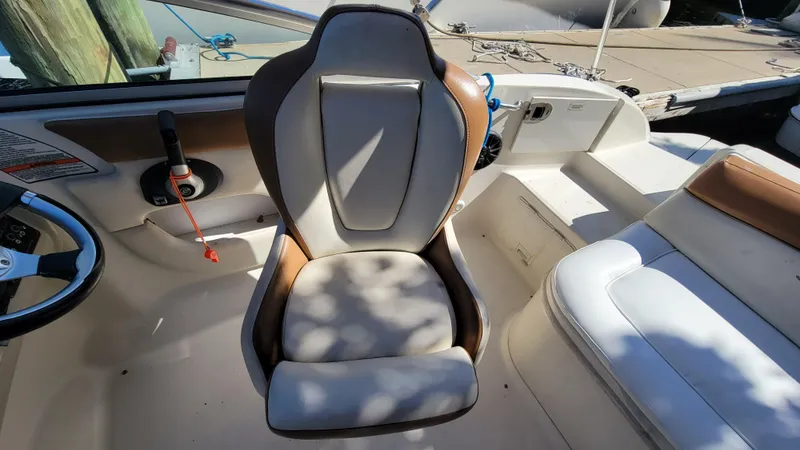 Slide: The Image of 2007 Sea Ray SunDeck 200 boat interior with captain's chair and steering wheel. - 15