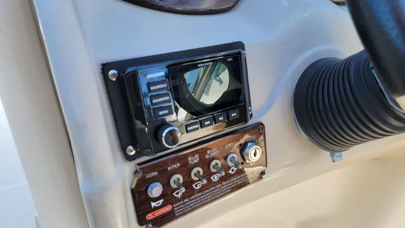Slide: The Image of Control panel of 2007 Sea Ray SunDeck 200 boat with radio and switches. - 17