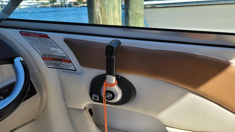 Slide: The Image of 2007 Sea Ray SunDeck 200 boat interior with steering wheel and throttle control. - 19