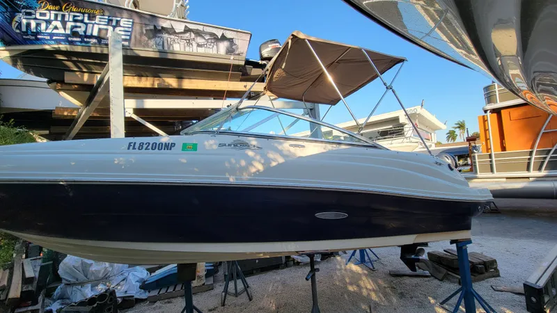 Slide: The Image of 2007 Sea Ray SunDeck 200 boat on stands, outdoor marina setting. - 2