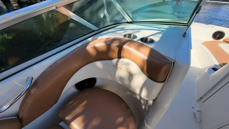 Slide: The Image of 2007 Sea Ray SunDeck 200 boat interior with tan seating and cup holders. - 21