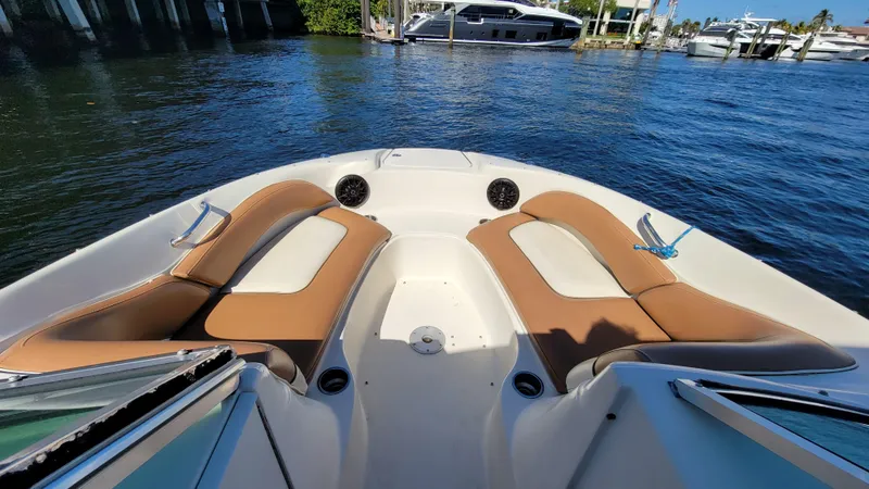 Slide: The Image of 2007 Sea Ray SunDeck 200 boat interior with tan seating on calm water. - 23