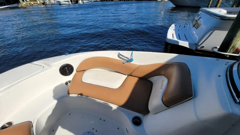 Slide: The Image of 2007 Sea Ray SunDeck 200 boat interior with tan seating by the water. - 25