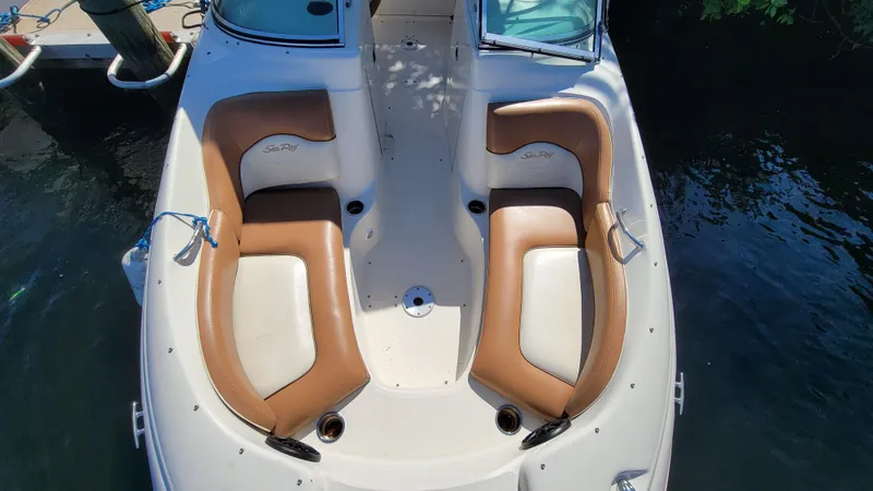 Slide: The Image of 2007 Sea Ray SunDeck 200 boat with tan seating, docked on calm water. - 28