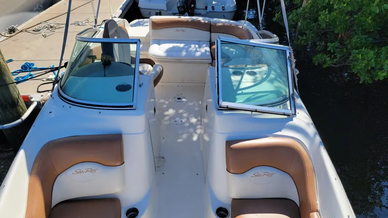 Slide: The Image of 2007 Sea Ray SunDeck 200 boat interior with tan seating and open windshield. - 30