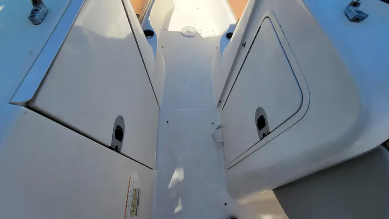 Slide: The Image of 2007 Sea Ray SunDeck 200 interior with storage compartments and seating area. - 33