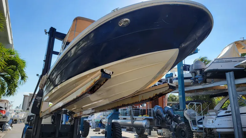 Slide: The Image of 2007 Sea Ray SunDeck 200 on a lift, showcasing its sleek design and hull. - 34