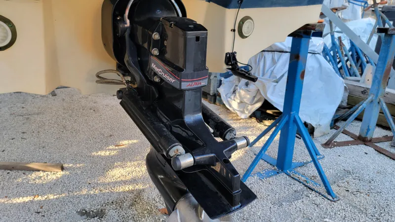 Slide: The Image of 2007 Sea Ray SunDeck 200 outboard motor on gravel, supported by blue stands. - 39