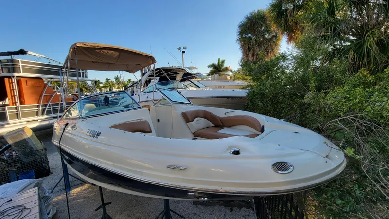 Slide: The Image of 2007 Sea Ray SunDeck 200 boat docked near lush greenery and other boats. - 4