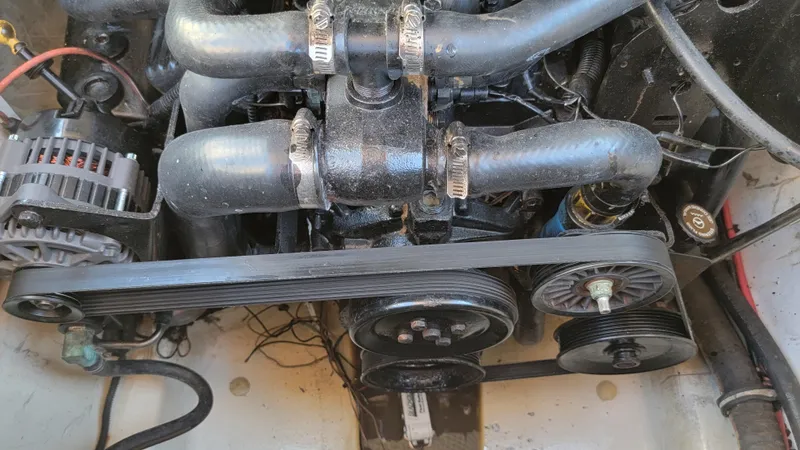 Slide: The Image of Engine of a 2007 Sea Ray SunDeck 200 boat, featuring belts and hoses. - 45