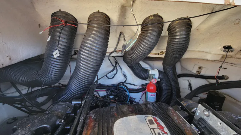 Slide: The Image of Engine compartment of 2007 Sea Ray SunDeck 200 with ventilation hoses and fire extinguisher. - 47