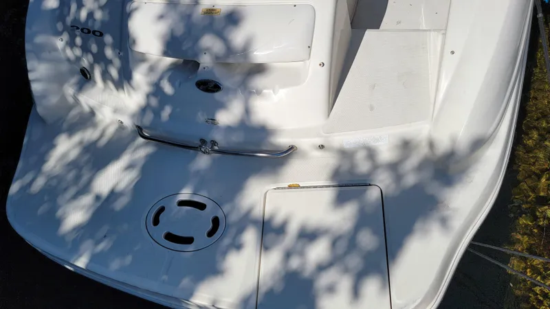 Slide: The Image of 2007 Sea Ray SunDeck 200 boat deck with shadows and sleek white design. - 6