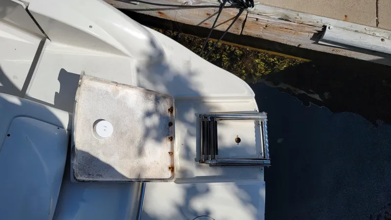 Slide: The Image of 2007 Sea Ray SunDeck 200 boat deck with ladder and dock. - 8