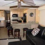 Slide: The Image of Interior of 2001 Stardust Cruisers Desert Oasis, featuring kitchen and seating area with ceiling fan. - 2