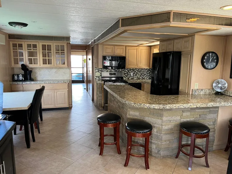 Slide: The Image of Spacious kitchen in 2001 Stardust Cruisers Desert Oasis houseboat with modern amenities and seating. - 8