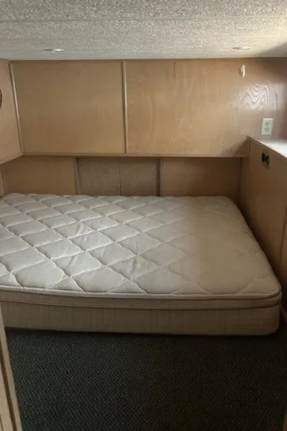 Slide: The Image of Interior of 2001 Stardust Cruisers Desert Oasis Week #30 with a cozy bed setup. - 9