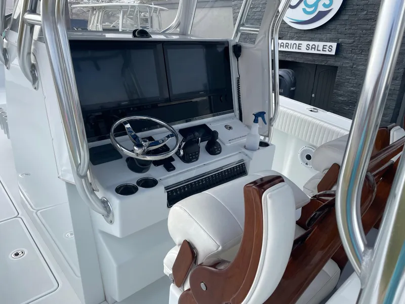 Slide: The Image of 2019 Freeman 37 boat cockpit with dual screens and steering wheel. - 15