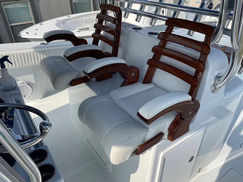 Slide: The Image of Luxurious seating on a 2019 Freeman 37 boat with white cushions and wooden accents. - 18