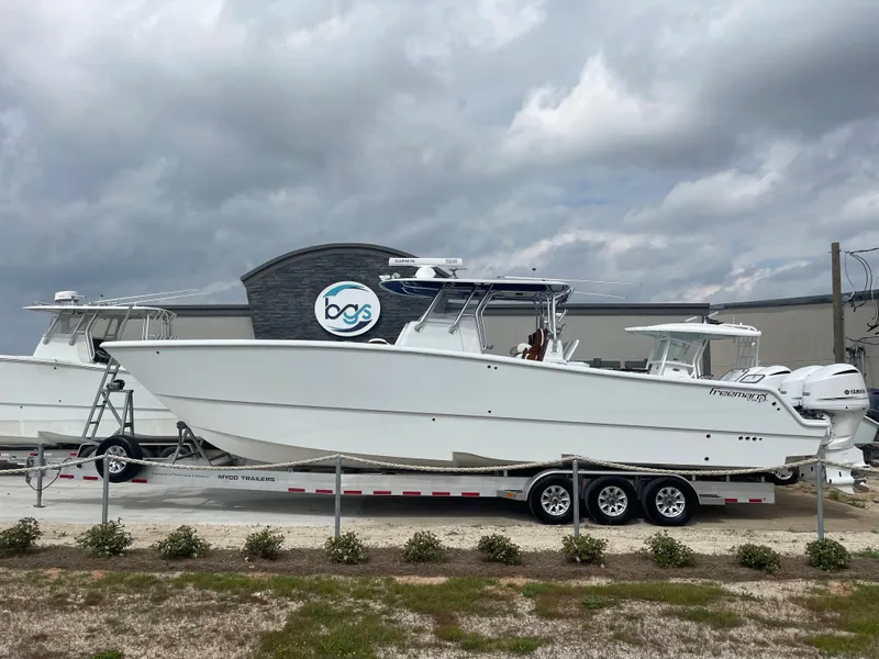 Slide: The Image of 2019 Freeman 37 boat on a trailer at a dealership. - 2