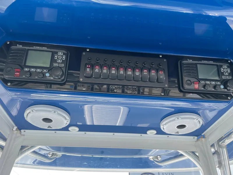 Slide: The Image of Control panel of a 2019 Freeman 37 boat with radios and switches. - 38
