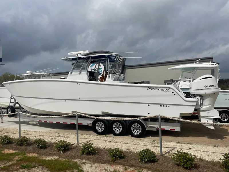 Slide: The Image of 2019 Freeman 37 boat on a trailer with Yamaha outboard engines. - 4